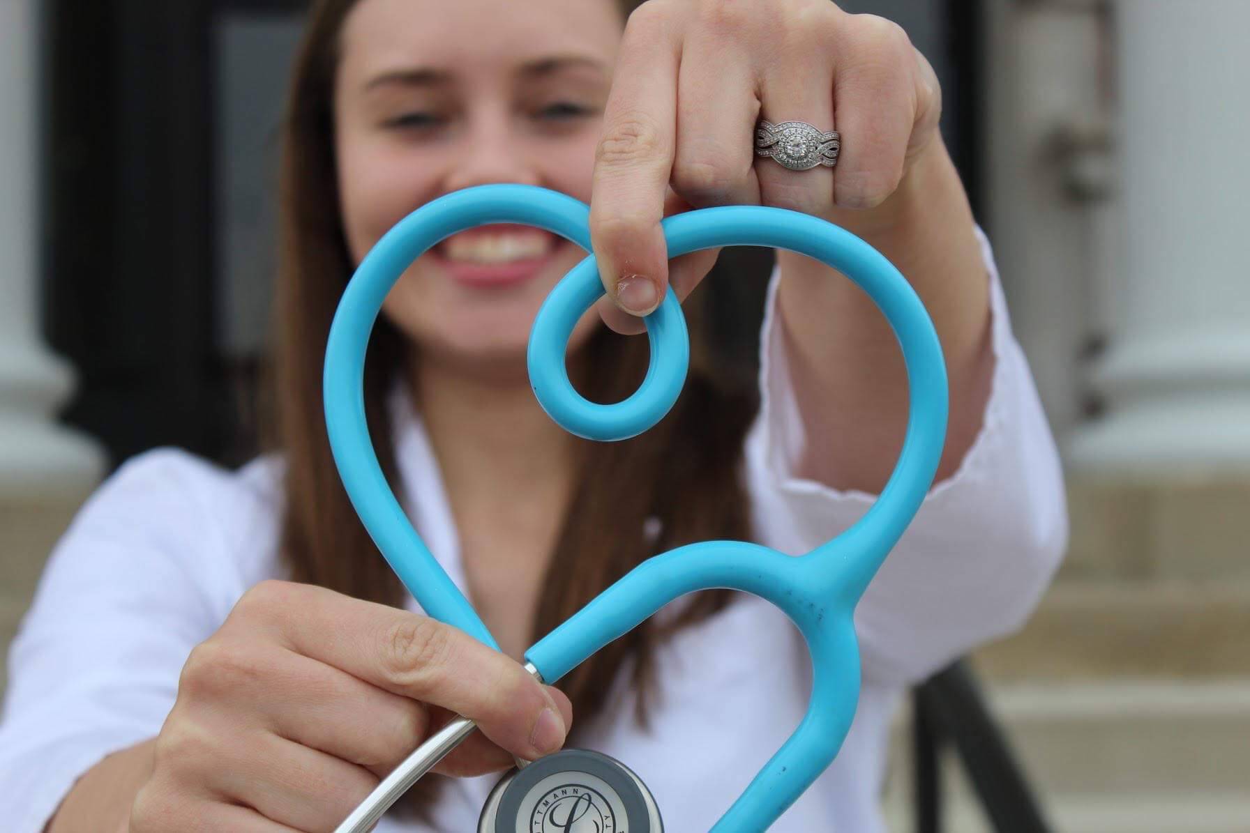 ROTC Nursing Cadet holding up a stethoscope in the shape of a heart